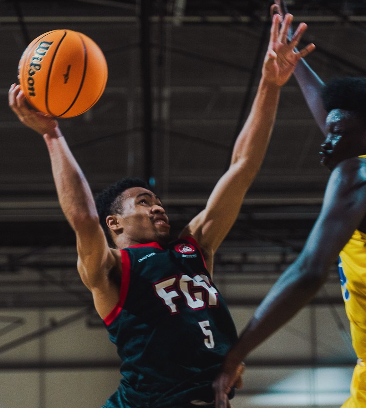 Kylin Green in FCP Spartans jersey, driving for a layup